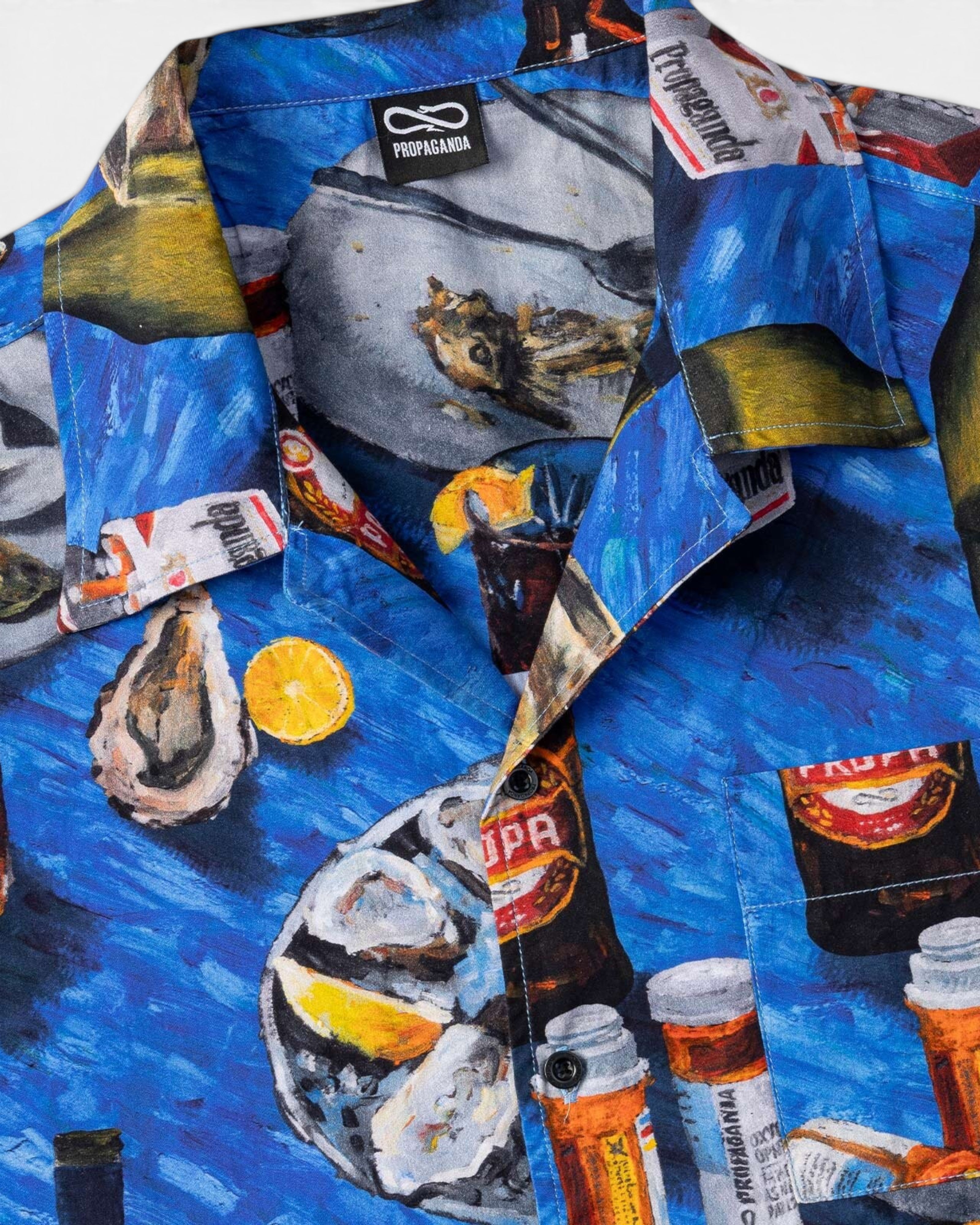 Astrofat Propaganda short-sleeve cotton shirt featuring an all-over blue print of oysters, drinks, and lemon slices.
