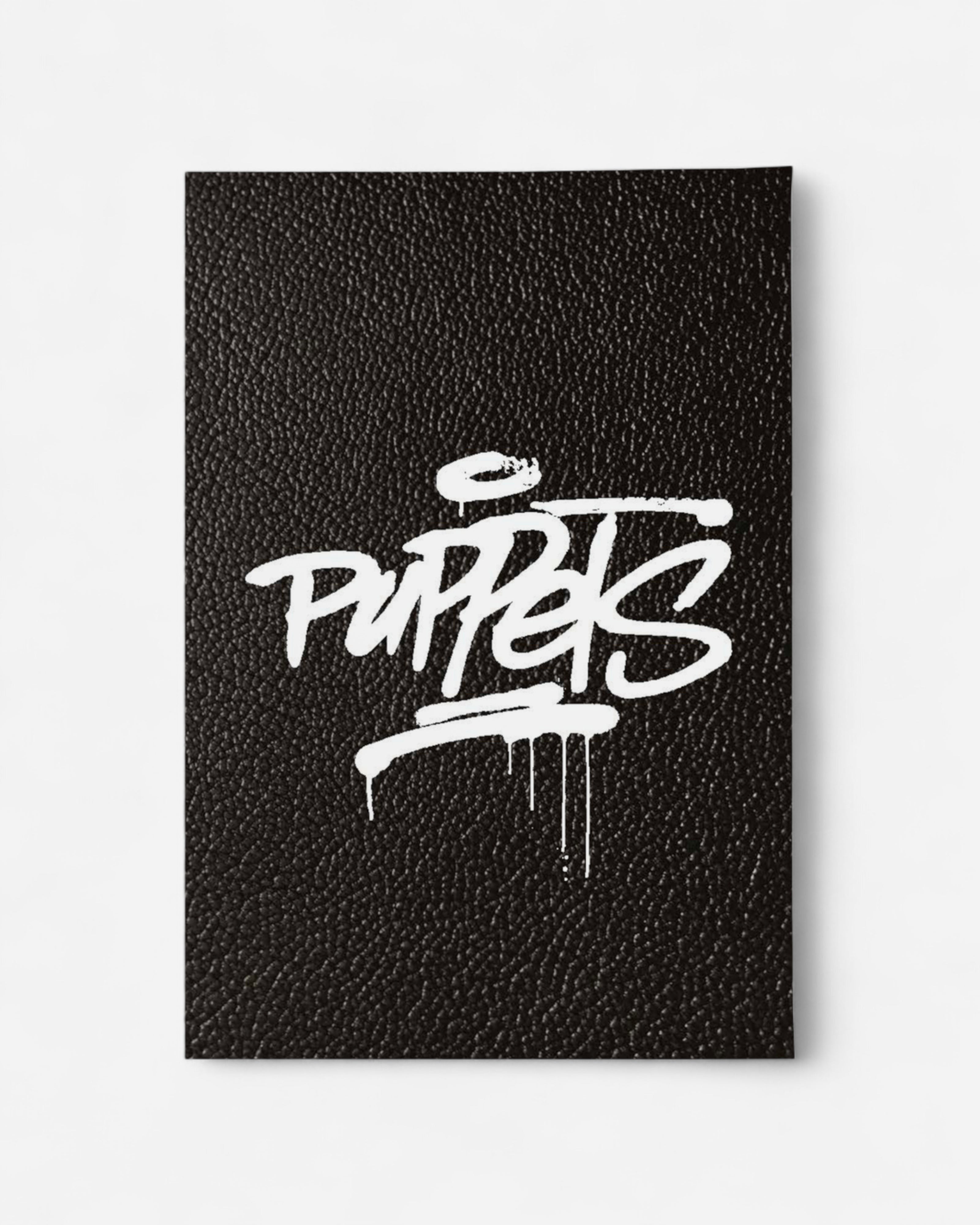 Astrofat PUPPETS: 30 Italian Masters Of Hip Hop Characters Vol.1 book cover with white graffiti-style text on black textured background.
