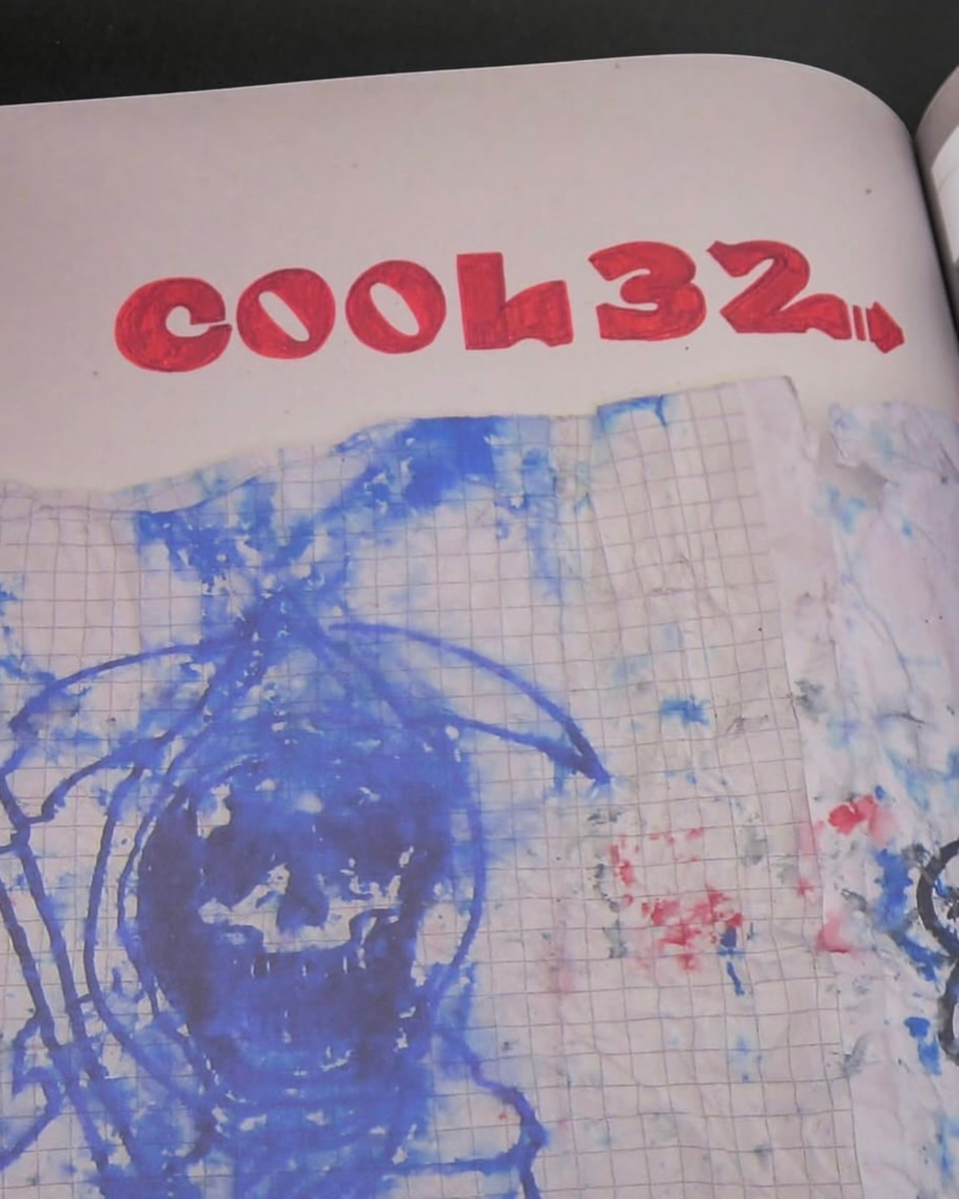 Astrofat Reincarnations book page featuring a blue ink skull drawing on graph paper and red text reading COOL32.
