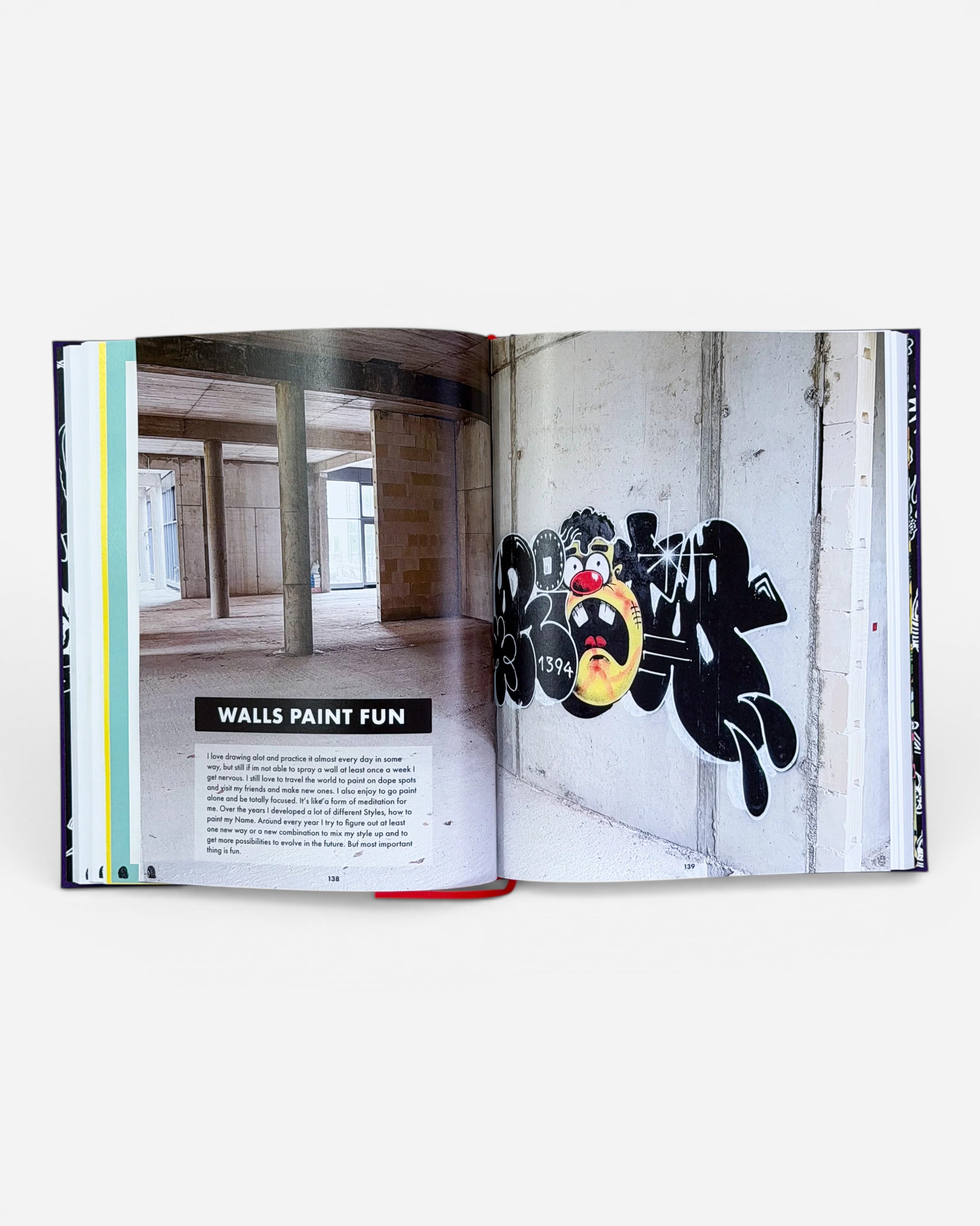Astrofat RIOT1394 Ultraworld book featuring graffiti art on a concrete wall. The graffiti is black with a cartoonish face and the number 1394.