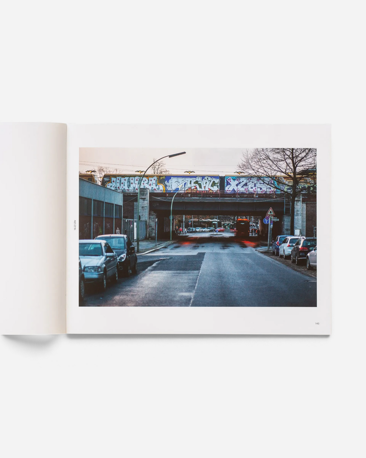 A spread from the Astrofat photo book Schriftzüge showing a graffiti-covered Berlin S-Bahn train crossing a bridge.