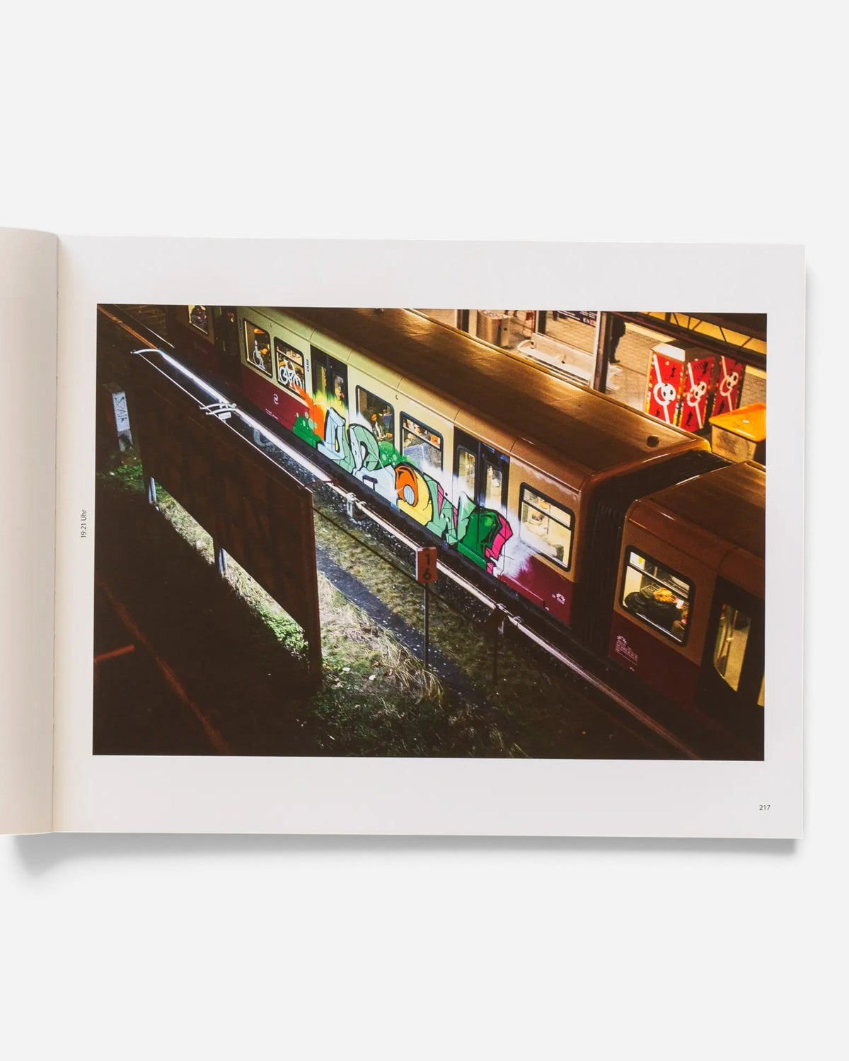 Astrofat Schriftzüge photography book open to a page showing a Berlin S-Bahn train with colorful graffiti art