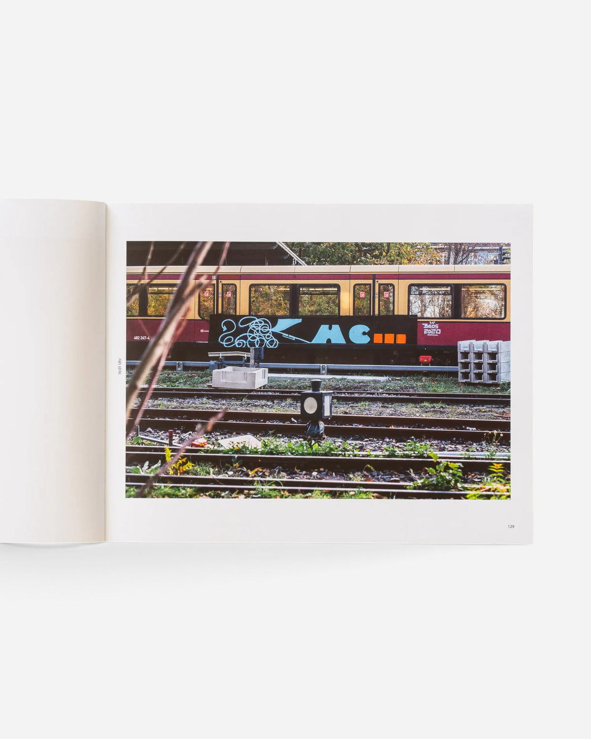 A spread from the Astrofat photography book Schriftzüge showing a Berlin S-Bahn train with graffiti art on tracks.