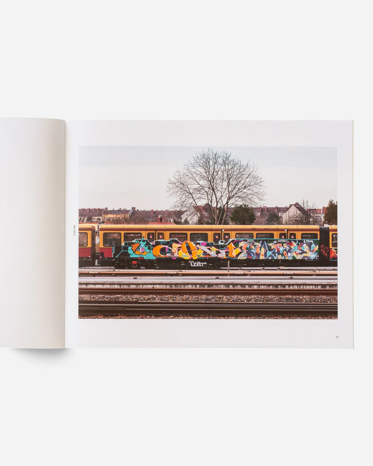 A double-page spread from the Astrofat photobook Schriftzüge showing a graffiti-covered Berlin S-Bahn train in winter.
