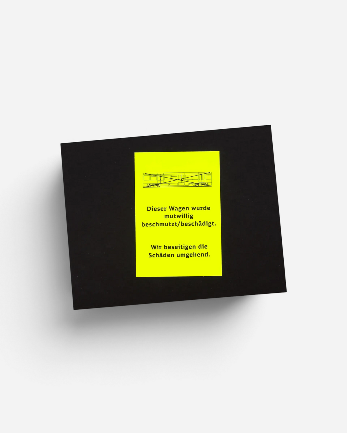 Astrofat Schriftzüge photography book featuring a black hardcover with a neon yellow warning sticker on the front.