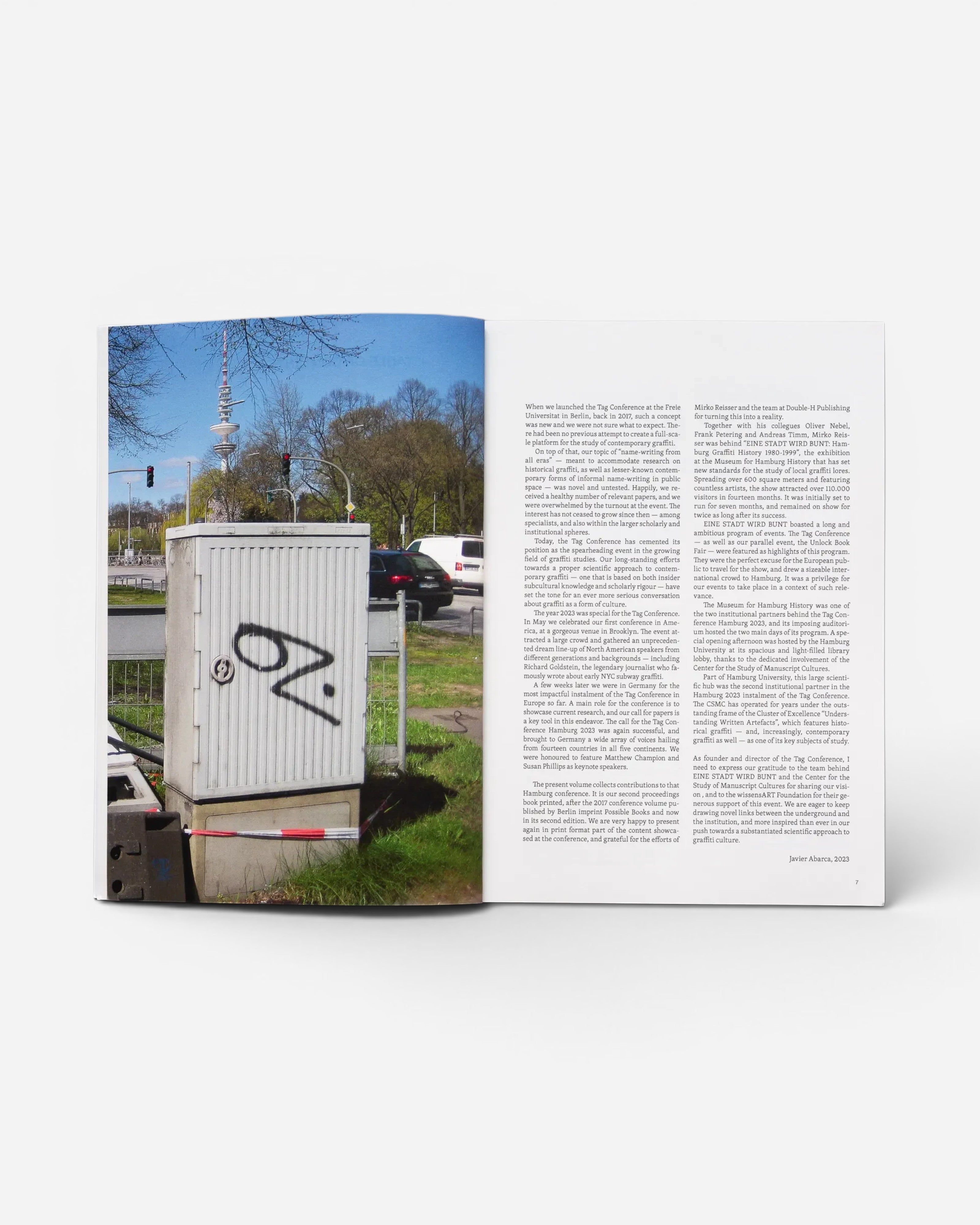 Astrofat TAG Name writing in public space book open to a page featuring text and a photo of graffiti in Hamburg
