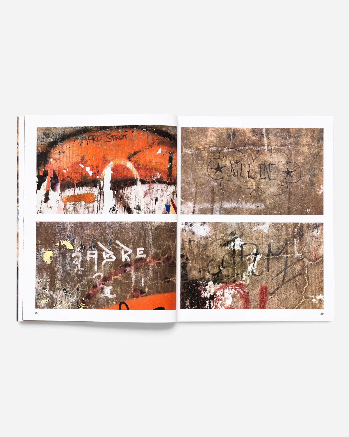 Astrofat Tag Town book open to pages 28 and 29 showing vintage New York graffiti tags and street art photography