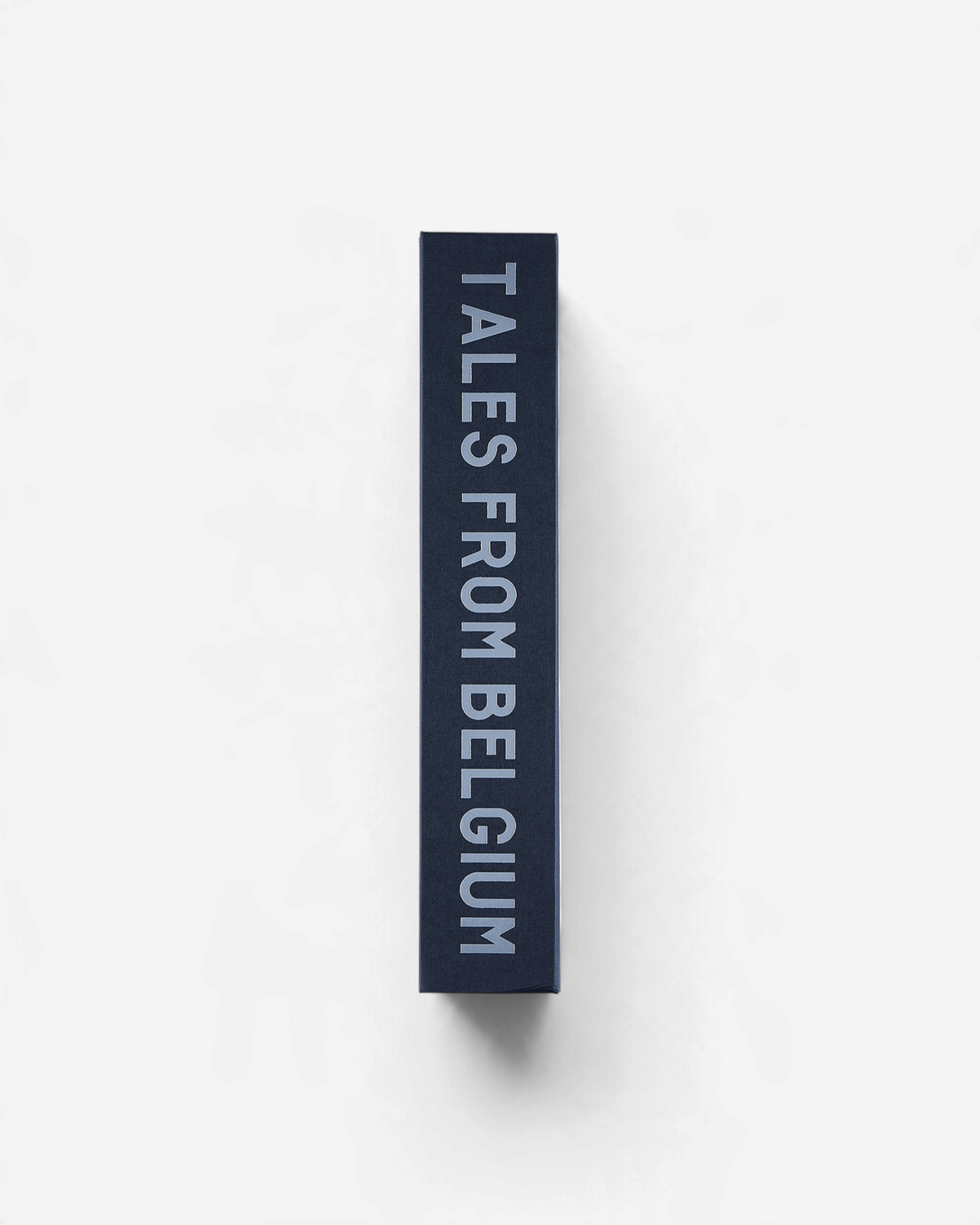 Astrofat Tales From Belgium book spine with white text on a black background, A4 vertical format.