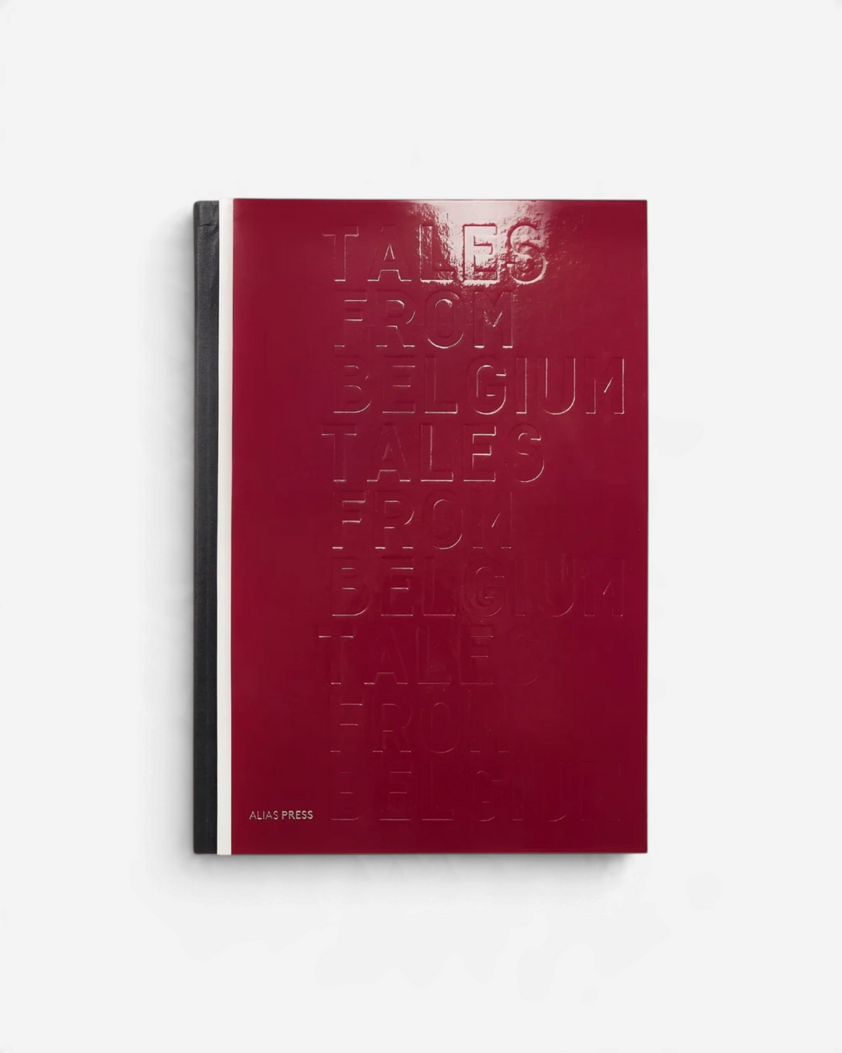Astrofat Tales from Belgium hardcover book in deep bordeaux red with embossed title text and a black spine.