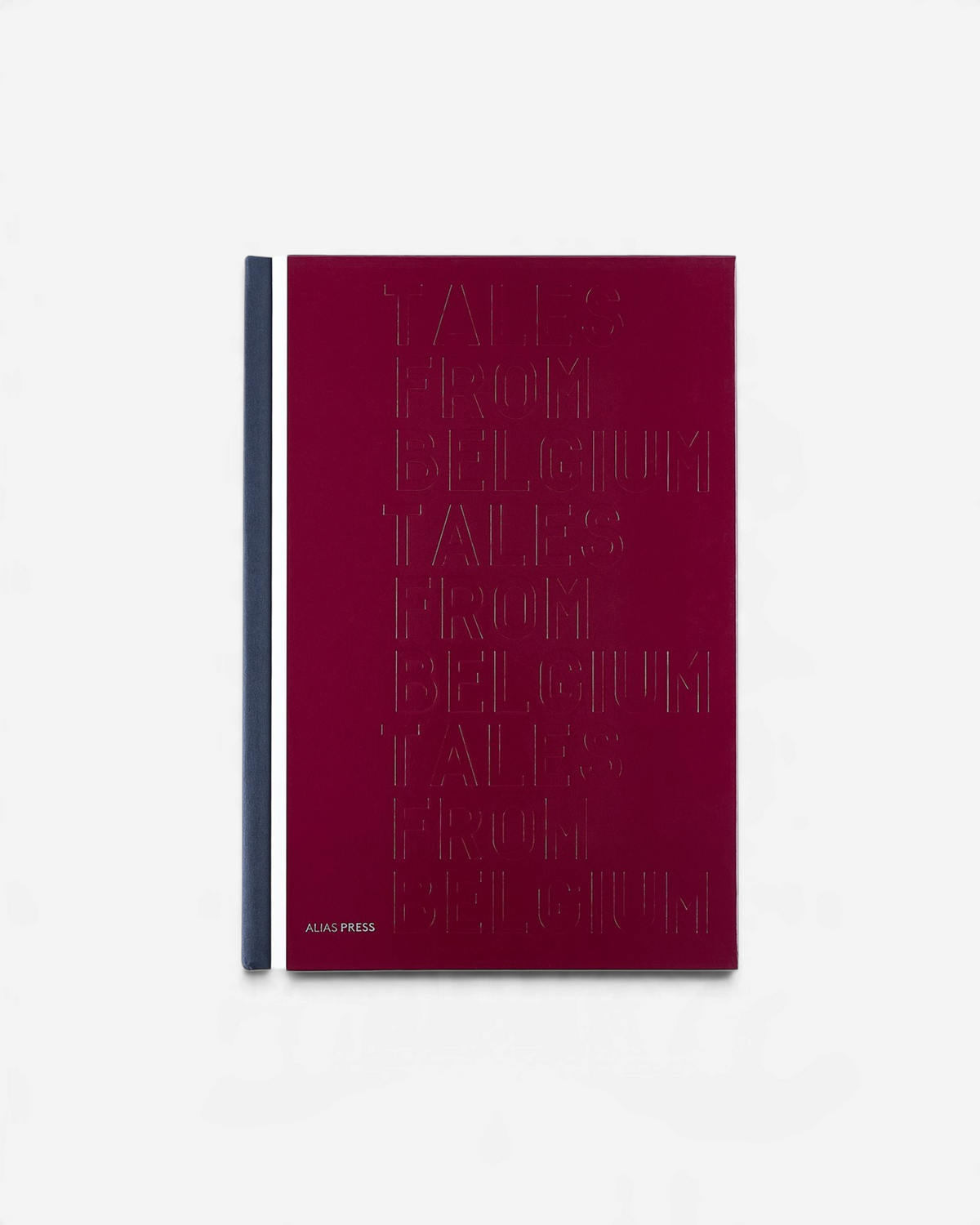 Astrofat Tales From Belgium hardcover book with a deep red cover and embossed typography on a white background.