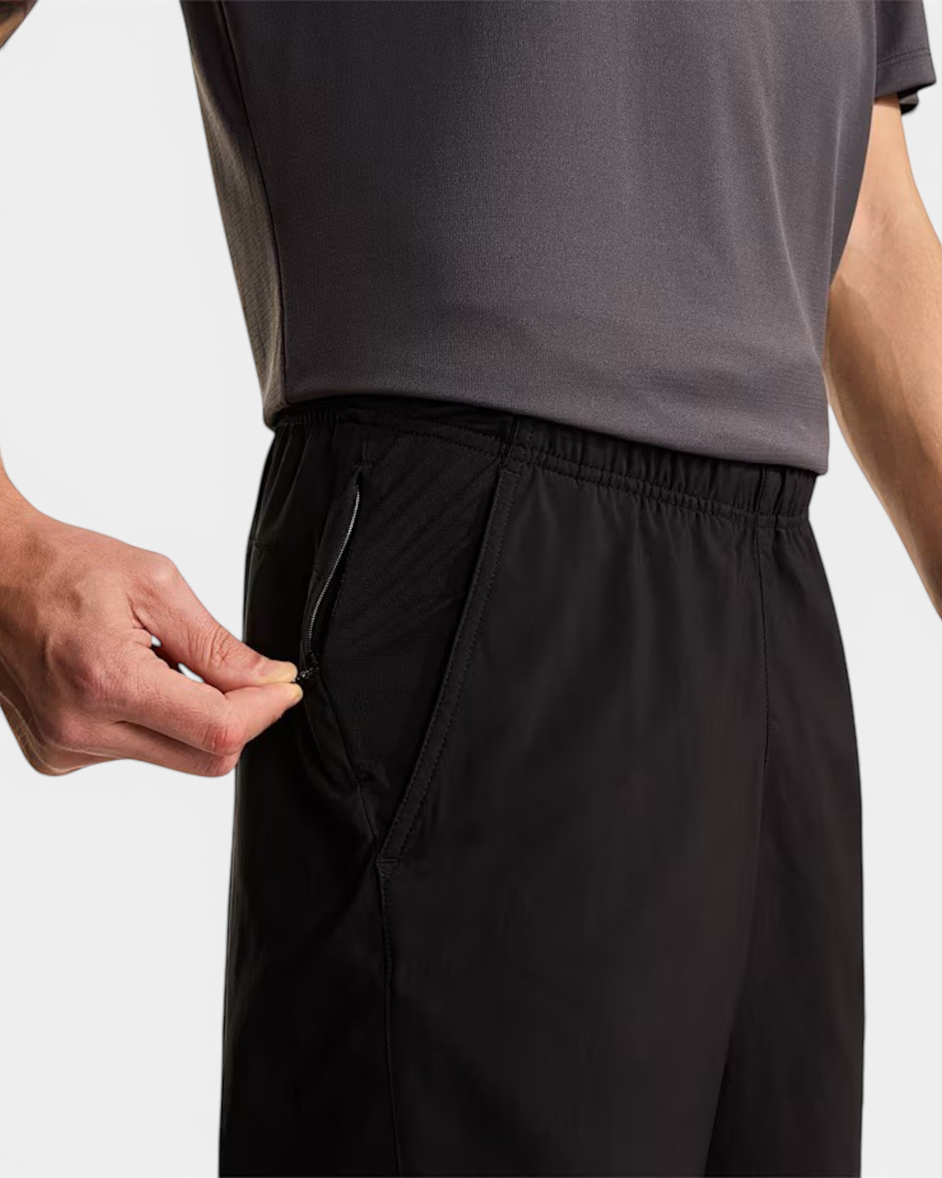 Astrofat The North Face black athletic shorts with a zippered pocket and mesh ventilation panels on a male model.