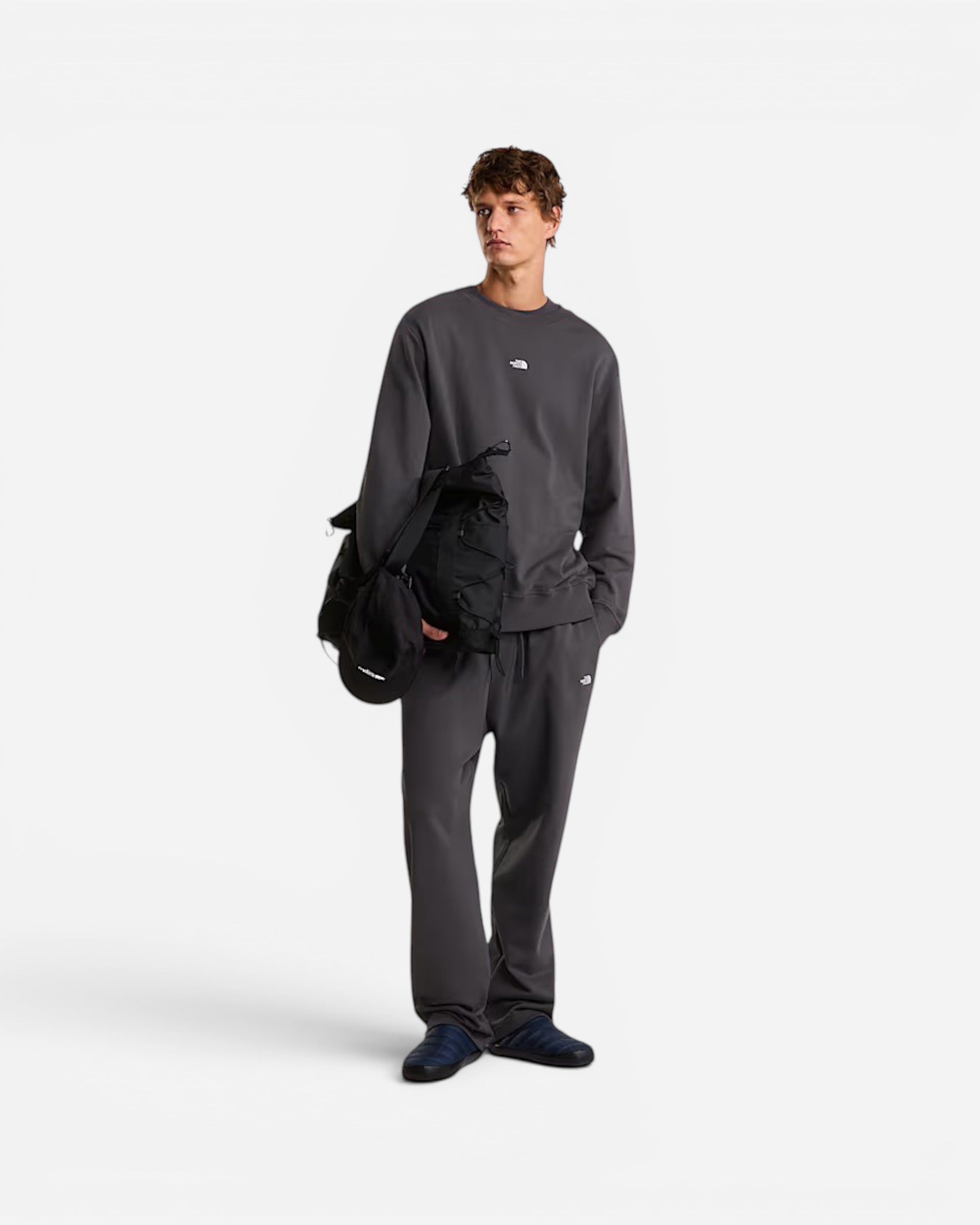Male model wearing Astrofat The North Face anthracite grey relaxed crewneck sweatshirt and matching sweatpants