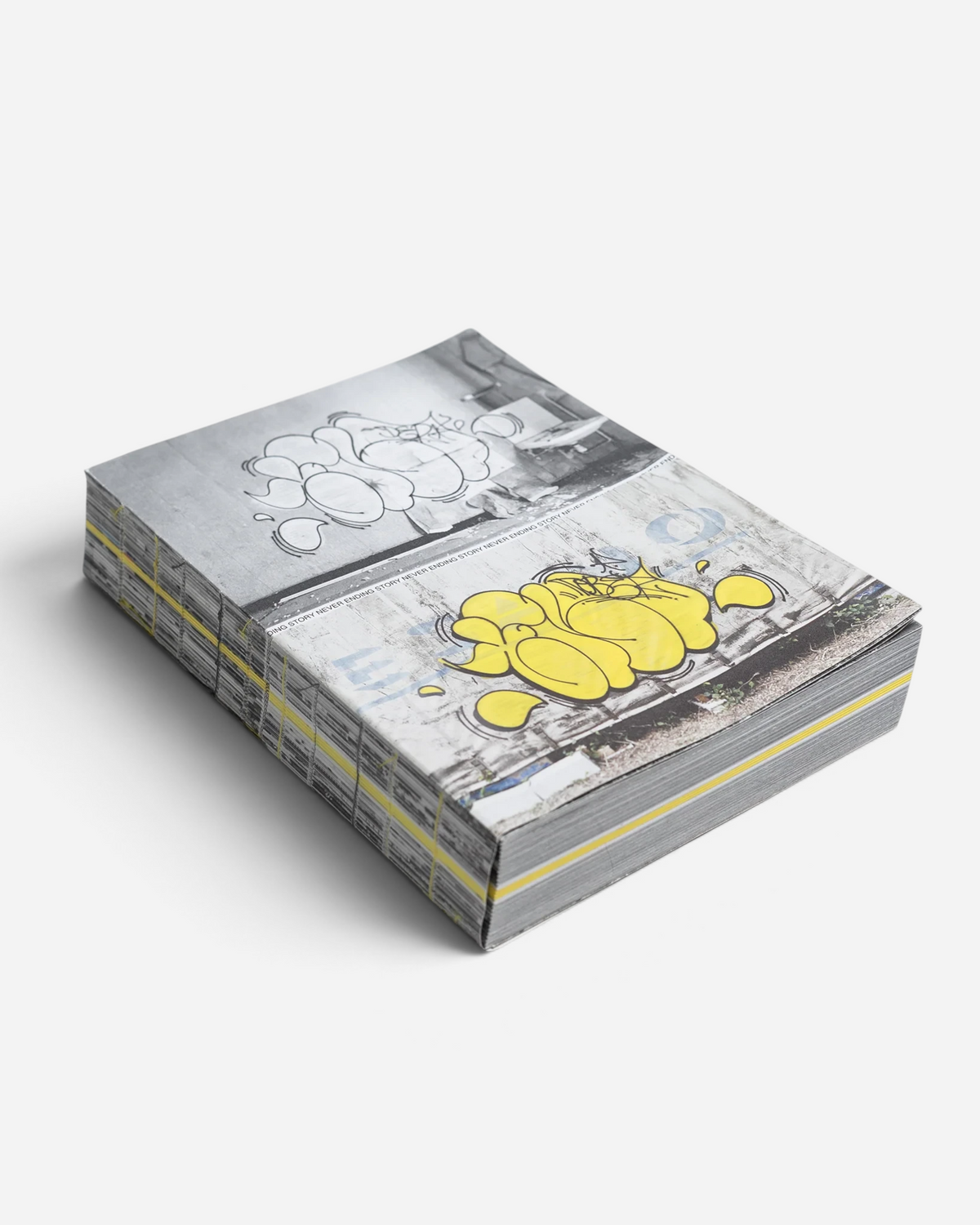 Astrofat Tilt Never Ending Story graffiti book with Swiss binding, featuring yellow and black throw-up art on cover
