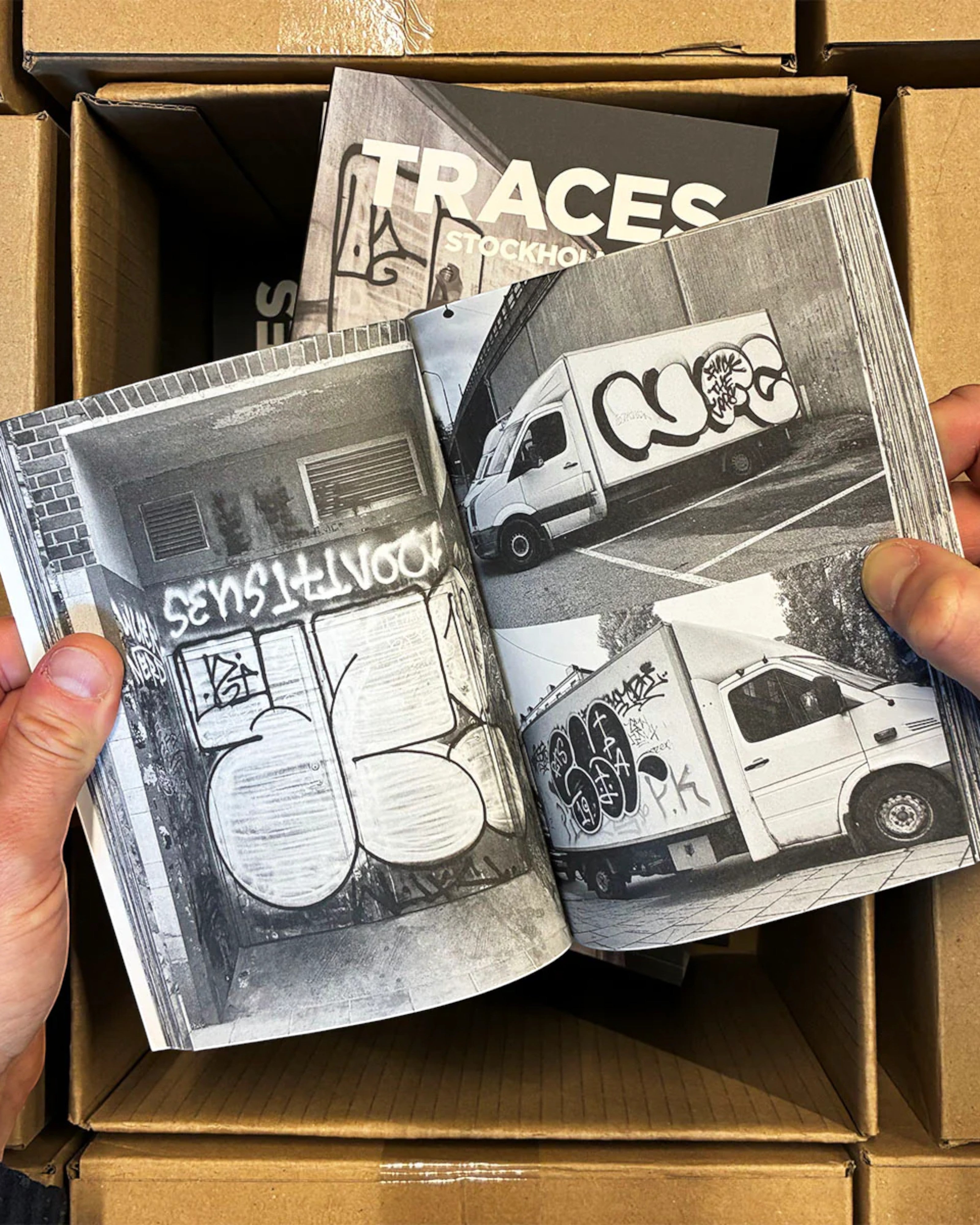 Astrofat Traces - Stockholm book featuring black and white graffiti tags and throw-ups on walls and trucks.