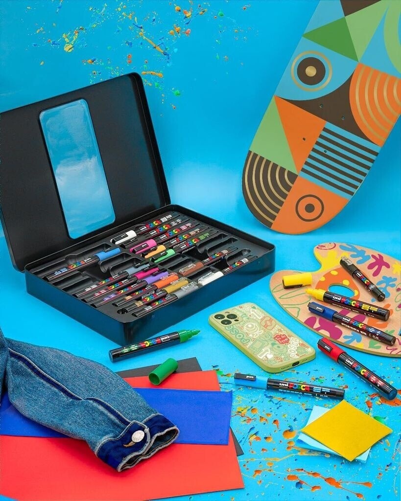 Astrofat Uni Posca marker set in a black storage case with assorted colorful acrylic paint pens on a blue background.