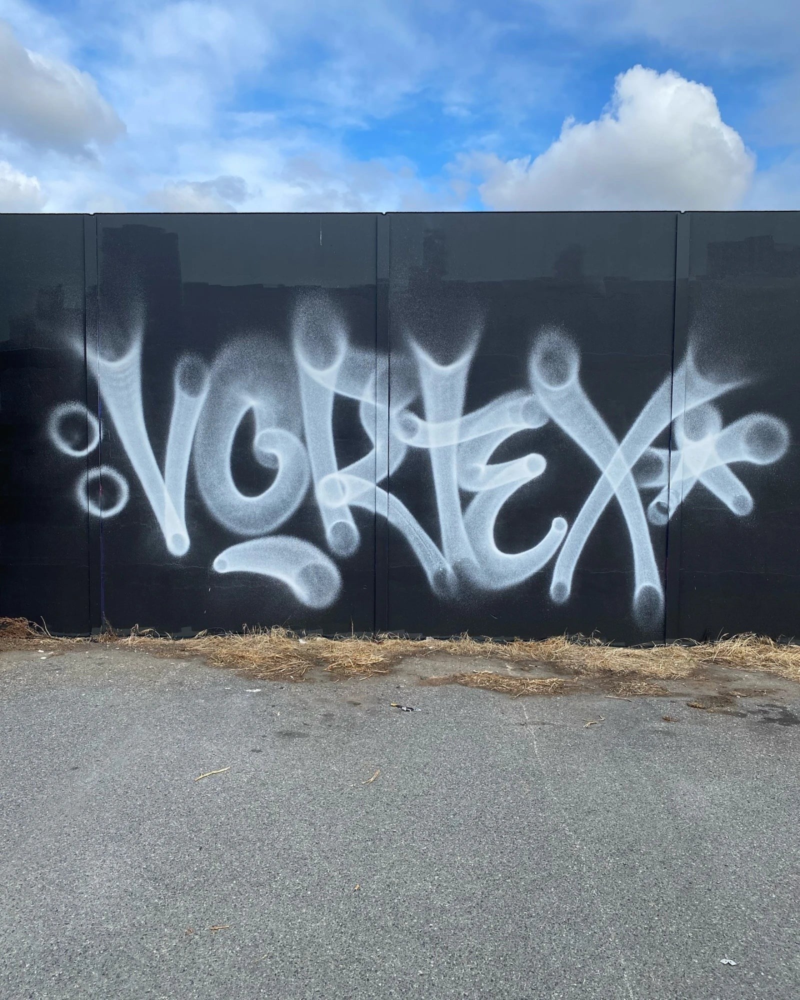 Astrofat Nightquill Vortex Halo Male fat cap spray paint graffiti on a black wall