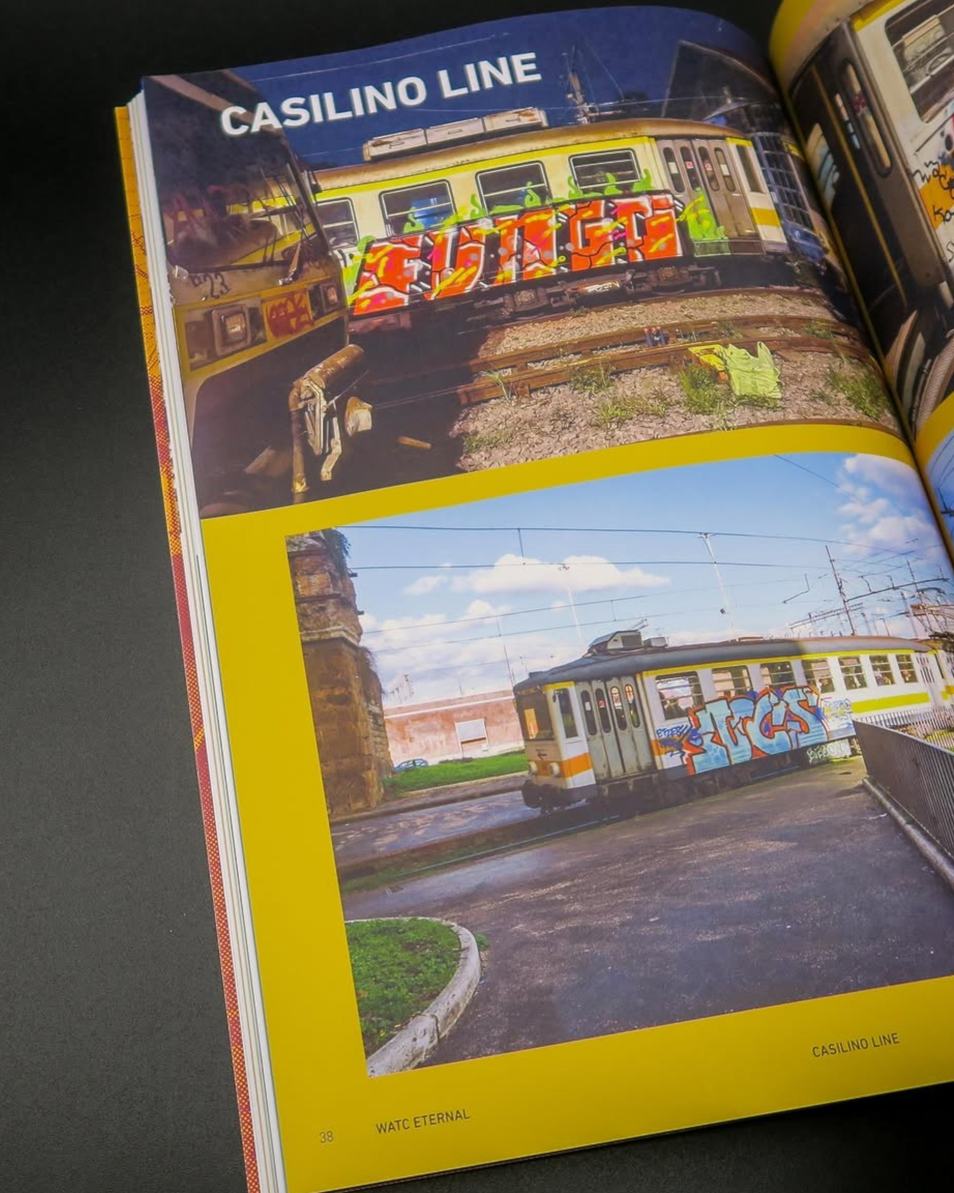 Astrofat We Are The City Eternal Roma 2026 book open to a page showing graffiti-covered trains on the Casilino line.