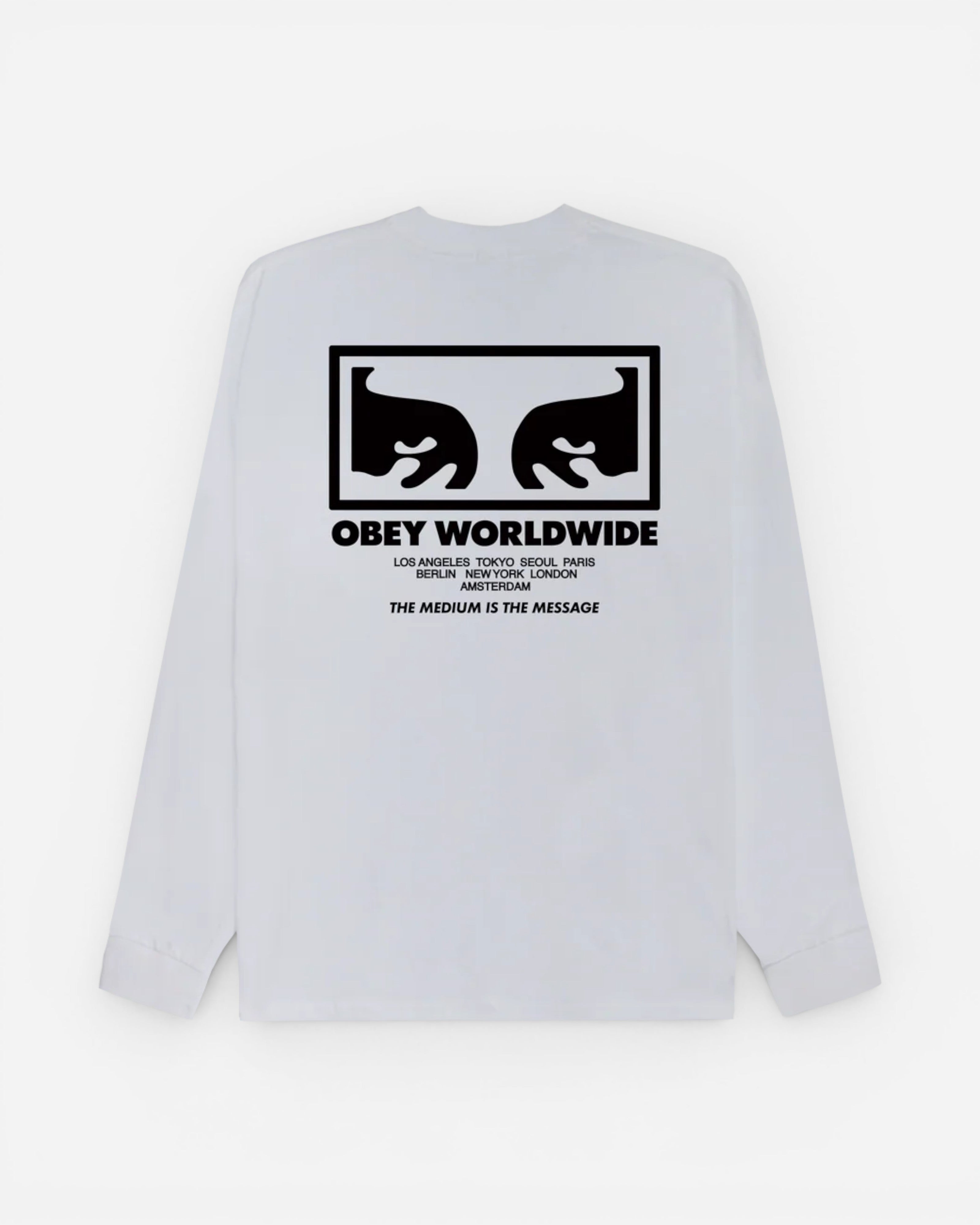 Astrofat white 100% cotton long sleeve t-shirt with 'Obey Worldwide' graphic and 'The Medium Is The Message' text on the back.